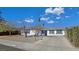 Well-maintained single-story home with desert landscaping and a spacious driveway on a sunny day at 3747 N Braewood South Ave, Las Vegas, NV 89120