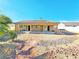 The home's backyard showcases low-maintenance desert landscaping and a covered patio at 3829 N Mayfield Ranch Rd, Pahrump, NV 89060