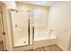 Updated bath with shower and tub combo with glass doors and wood-look floors at 3829 N Mayfield Ranch Rd, Pahrump, NV 89060