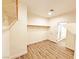 Walk-in closet featuring wood-look floors and a door leading to the bathroom at 3829 N Mayfield Ranch Rd, Pahrump, NV 89060