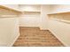 Spacious walk-in closet with wood-look flooring and ample shelving at 3829 N Mayfield Ranch Rd, Pahrump, NV 89060
