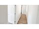 Bright hallway featuring wood-look floors and crisp white trim and doors at 3829 N Mayfield Ranch Rd, Pahrump, NV 89060