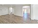 Open-concept living area with wood floors, white walls, and plenty of natural light at 3829 N Mayfield Ranch Rd, Pahrump, NV 89060