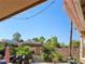 Secluded backyard with a tiki hut, mature trees, and comfortable seating, perfect for outdoor enjoyment at 4016 Mountain Trek St, Las Vegas, NV 89129