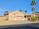 Inviting home featuring a three-car garage, neutral tones, and a well-kept front yard with palm trees at 4016 Mountain Trek St, Las Vegas, NV 89129