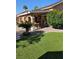 Outdoor patio featuring a dining set and ample entertaining space, seamlessly connected to a lush green yard at 4016 Mountain Trek St, Las Vegas, NV 89129