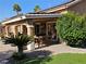 Covered patio featuring an outdoor dining area with a ceiling fan, perfect for relaxing and entertaining guests at 4016 Mountain Trek St, Las Vegas, NV 89129