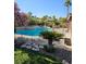 Inviting backyard featuring a sparkling pool, spa, and lush landscaping, creating a serene and private outdoor retreat at 4016 Mountain Trek St, Las Vegas, NV 89129