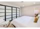 Stylish bedroom with closet, seating area, wood-style floors, and a view to the bathroom at 4072 E Harmon Ave, Las Vegas, NV 89121