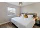Comfortable bedroom with a large window, wood-style floors, and stylish light fixture at 4072 E Harmon Ave, Las Vegas, NV 89121