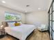Well-lit bedroom with a seating area, wood-style floors, and a large window at 4072 E Harmon Ave, Las Vegas, NV 89121