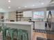 Stylish kitchen with white countertops, stainless steel appliances, an island with seating and open shelving at 4072 E Harmon Ave, Las Vegas, NV 89121