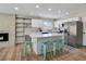Charming kitchen featuring white cabinets, a large island, stainless appliances, and a cozy fireplace at 4072 E Harmon Ave, Las Vegas, NV 89121