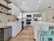 Modern kitchen featuring white cabinets, stainless steel appliances, and a spacious island with seating at 4072 E Harmon Ave, Las Vegas, NV 89121