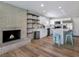 Modern kitchen with white cabinets, stainless steel appliances, a brick fireplace, and open shelving at 4072 E Harmon Ave, Las Vegas, NV 89121