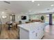 Open concept living area featuring a kitchen island, dining table, and comfortable seating area at 4072 E Harmon Ave, Las Vegas, NV 89121