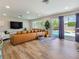 Bright living room featuring a leather sectional sofa and sliding glass doors leading to the pool area at 4072 E Harmon Ave, Las Vegas, NV 89121
