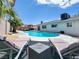 Resort-style pool surrounded by lounge chairs, patio, and lush greenery, offering a private escape at 4072 E Harmon Ave, Las Vegas, NV 89121