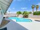 Enjoy swimming in the backyard pool with palm trees and ample deck space for lounging at 4072 E Harmon Ave, Las Vegas, NV 89121