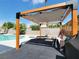Inviting backyard pool area with a pergola, lounge seating, and privacy walls at 4072 E Harmon Ave, Las Vegas, NV 89121