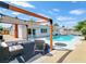 The backyard includes a pool, lounge chairs, and a covered patio area, perfect for relaxation at 4072 E Harmon Ave, Las Vegas, NV 89121
