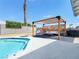 A pool in a backyard featuring a covered patio, offering shade and a relaxing outdoor space at 4072 E Harmon Ave, Las Vegas, NV 89121
