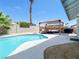 Beautiful backyard pool with a covered patio, offering a private oasis for relaxation and entertainment at 4072 E Harmon Ave, Las Vegas, NV 89121