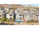 Overhead view displaying a community of homes with tidy landscaping, backyard pools, and desert views at 41 Strada Moscato, Henderson, NV 89011