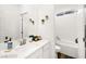 A bright white bathroom includes a vanity with a white stone counter and a combined shower and tub at 41 Strada Moscato, Henderson, NV 89011