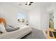 A bedroom includes a ceiling fan and large window for natural light and a full closet for storage at 41 Strada Moscato, Henderson, NV 89011