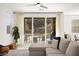 Bright living room with a comfortable sofa and sliding doors to the outdoor area with a pool at 41 Strada Moscato, Henderson, NV 89011