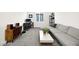 Bright living room featuring contemporary gray sofa, work station, and stylish decor at 41 Strada Moscato, Henderson, NV 89011