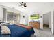 Bright main bedroom with ceiling fan, a TV, and balcony access with mountain views at 41 Strada Moscato, Henderson, NV 89011
