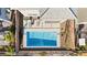 Aerial view of backyard pool with modern lounge furniture and desert rock landscaping at 41 Strada Moscato, Henderson, NV 89011