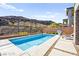 Beautiful backyard swimming pool surrounded by concrete patio and desert landscape with mountain views in the background at 41 Strada Moscato, Henderson, NV 89011