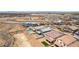 Expansive aerial view of a vibrant neighborhood with modern homes and community amenities, including a pool and desert landscaping at 453 Winter Dove Ave, Henderson, NV 89011