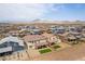 A home and community is shown from above, featuring a fenced backyard with a patch of synthetic grass at 453 Winter Dove Ave, Henderson, NV 89011