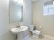 Bathroom featuring a pedestal sink, a toilet, and a neutral color scheme at 453 Winter Dove Ave, Henderson, NV 89011