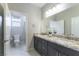 Bathroom features a granite countertop double vanity with a view of the toilet and shower at 453 Winter Dove Ave, Henderson, NV 89011