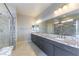 Modern bathroom features a double vanity with granite countertops and a glass-enclosed shower at 453 Winter Dove Ave, Henderson, NV 89011
