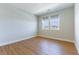 Bedroom featuring wood-look floors, neutral walls, and two windows allowing ample natural light at 453 Winter Dove Ave, Henderson, NV 89011
