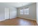 Bright bedroom featuring wood-look flooring and two windows allowing for natural light at 453 Winter Dove Ave, Henderson, NV 89011
