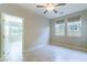 Well-lit bedroom with ceiling fan, tile floors, and open doorway offers a spacious feel at 453 Winter Dove Ave, Henderson, NV 89011