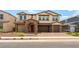 Charming two-story home featuring a stone archway, paver driveway, and a neutral color palette at 453 Winter Dove Ave, Henderson, NV 89011