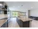 Bright kitchen with granite countertops, dark cabinetry, and stainless steel appliances at 453 Winter Dove Ave, Henderson, NV 89011