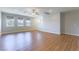 Spacious living room featuring hardwood floors, multiple windows, and ceiling fan at 453 Winter Dove Ave, Henderson, NV 89011
