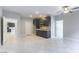 Cozy living room with tiled floors, a small kitchenette, and multiple doorways at 453 Winter Dove Ave, Henderson, NV 89011