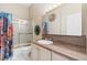 Standard bathroom featuring a shower-tub combo, vanity, and decorative accents at 4545 W Agate Ave, Las Vegas, NV 89139