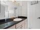 Well-lit bathroom featuring a spacious vanity, a large mirror, and a shower-tub combo at 4545 W Agate Ave, Las Vegas, NV 89139
