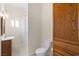 Compact bathroom featuring a toilet, sink with vanity, and a shower with a curtain at 4545 W Agate Ave, Las Vegas, NV 89139